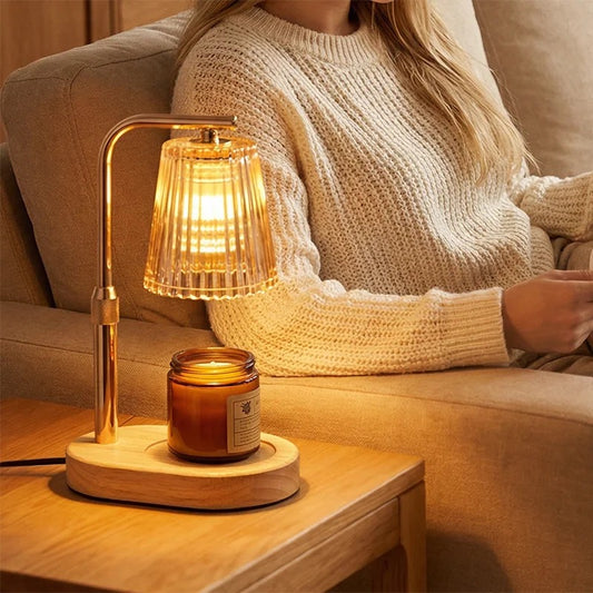 GatherGlow candle warmer lamp on a light-wood side table beside a cream sofa, walnut base and rose-gold arm